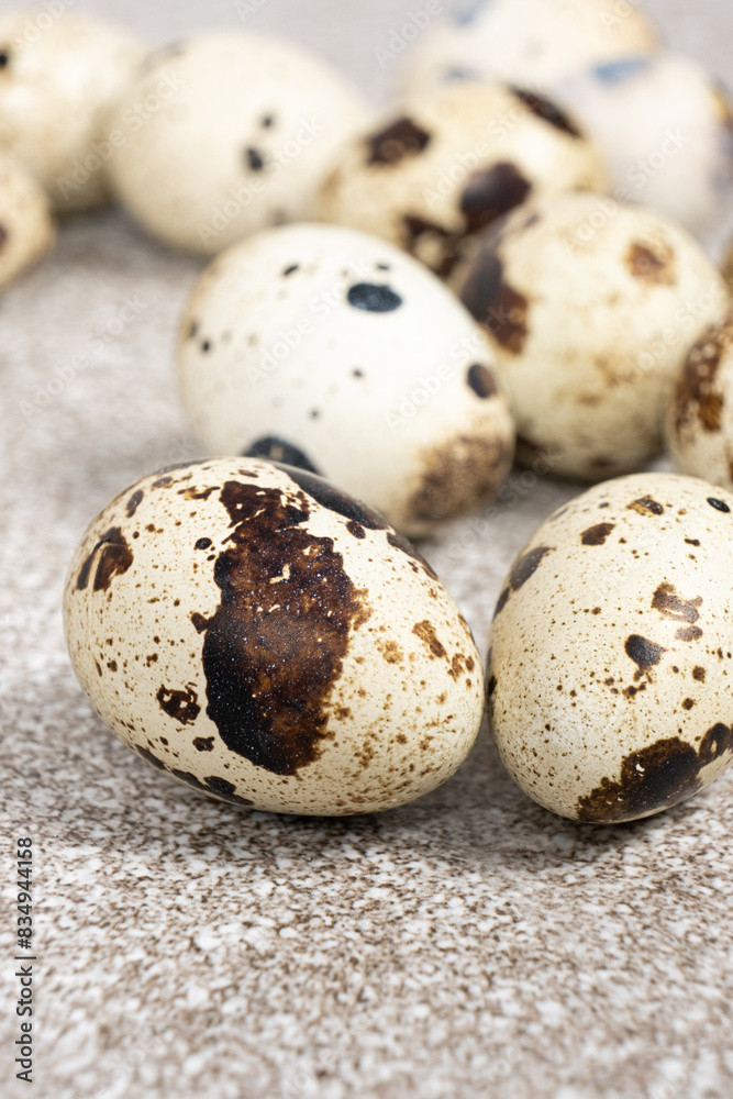 Quail eggs close-up on a gray background. Quail eggs close-up on a gray background.