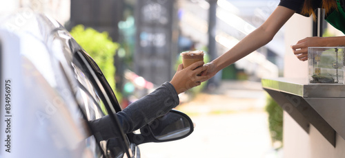 People pick up food and drink glasses from drive-thru counters and take them to eat at home and at work.