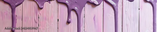 wet purple paint dripping on a wooden wall