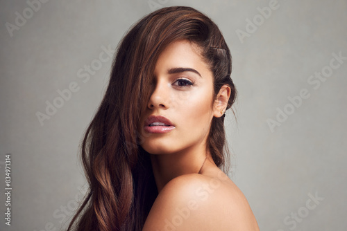 Aesthetic, hair and portrait of natural woman in studio on gray background for keratin or shampoo treatment. Beauty, cosmetics and wellness with confident model at salon for conditioning or haircare