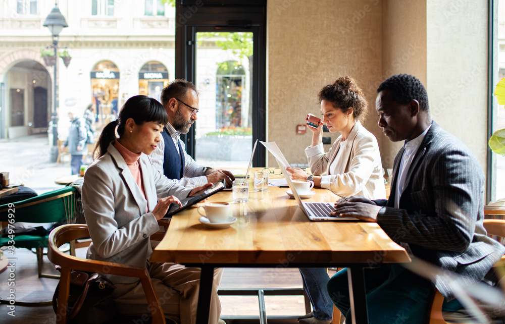 Business meeting in a cafe with diverse professionals