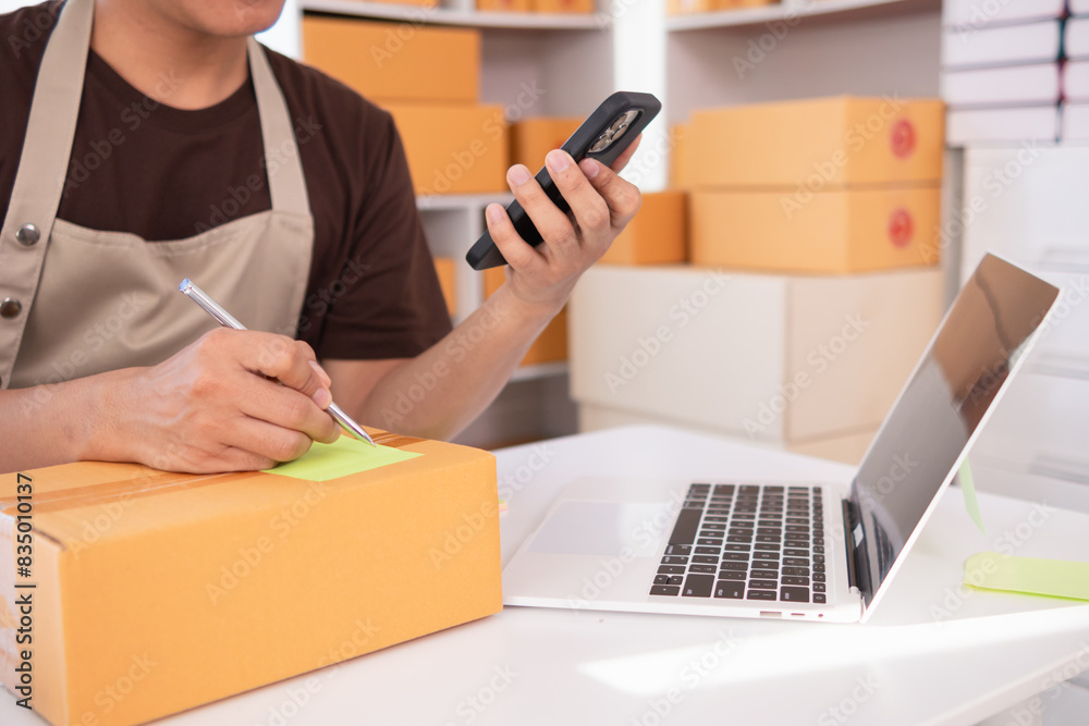businessman decides invest in small SME business at home by using laptop and smartphone do online marketing and sell things online through an application before packing products according to orders. businessman decides invest in small SME business at home by using laptop and smartphone do online marketing and sell things online through an application before packing products according to orders.