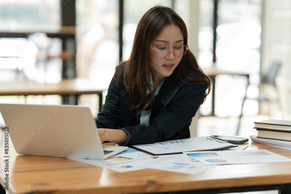 Asian business woman working on a tablet. Asian business woman working on a tablet.