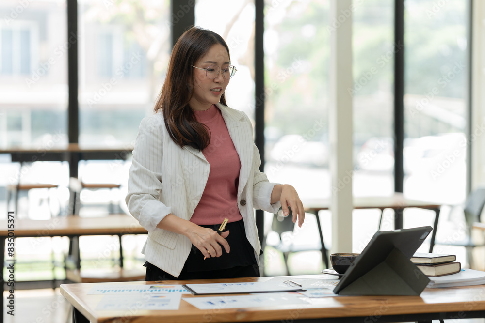 Asian businesswoman working on documents at office Asian businesswoman working on documents at office