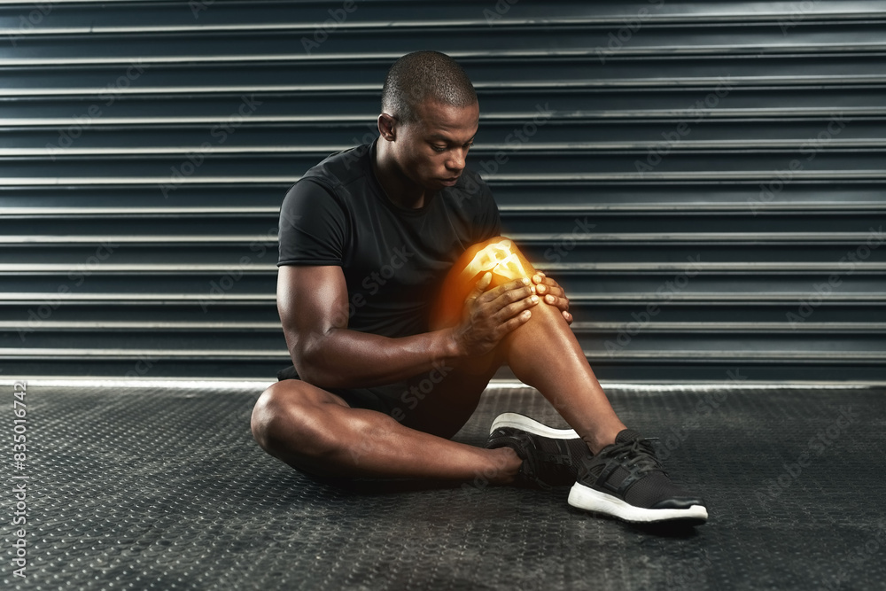 Obraz premium Fitness, injury and black man with knee pain on floor for sports accident, strain or muscle fatigue. Leg, overlay and athlete with exercise emergency for swollen tendon, inflammation or medical issue