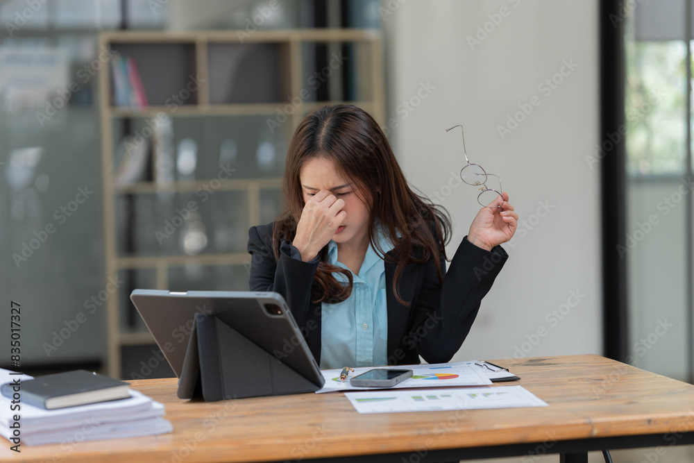 Asian business woman working on a tablet. Asian business woman working on a tablet.