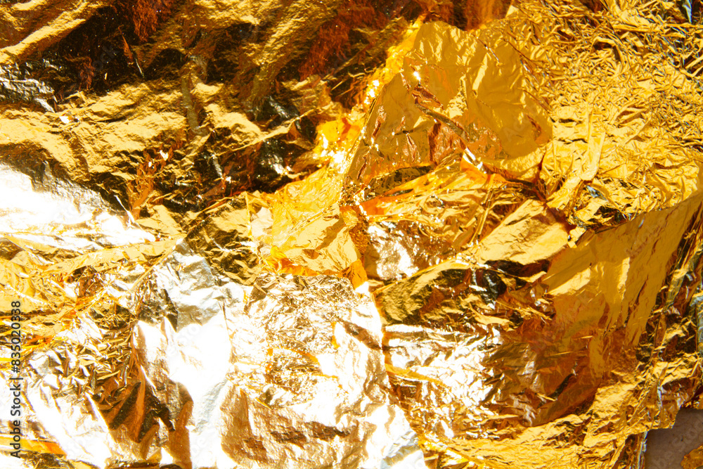 The background of crushed gold shines golden The background of crushed gold shines golden