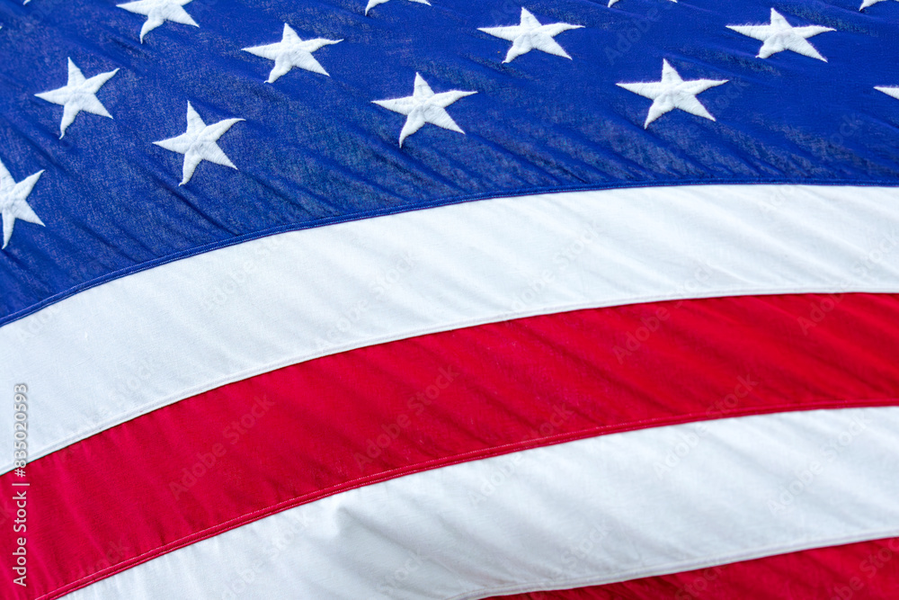 Close up of flag of United States of America while blowing in the wind while lit up by sunshine. Close up of flag of United States of America while blowing in the wind while lit up by sunshine.