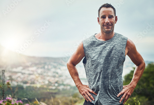 Portrait, fitness and man training in outdoors as runner for marathon competition with exercise, workout or cardio on mountain. Strong, male athlete and nature for wellness, running or training goal