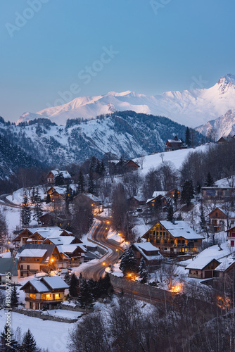 French Alps village with snowy mountain and lighted roads