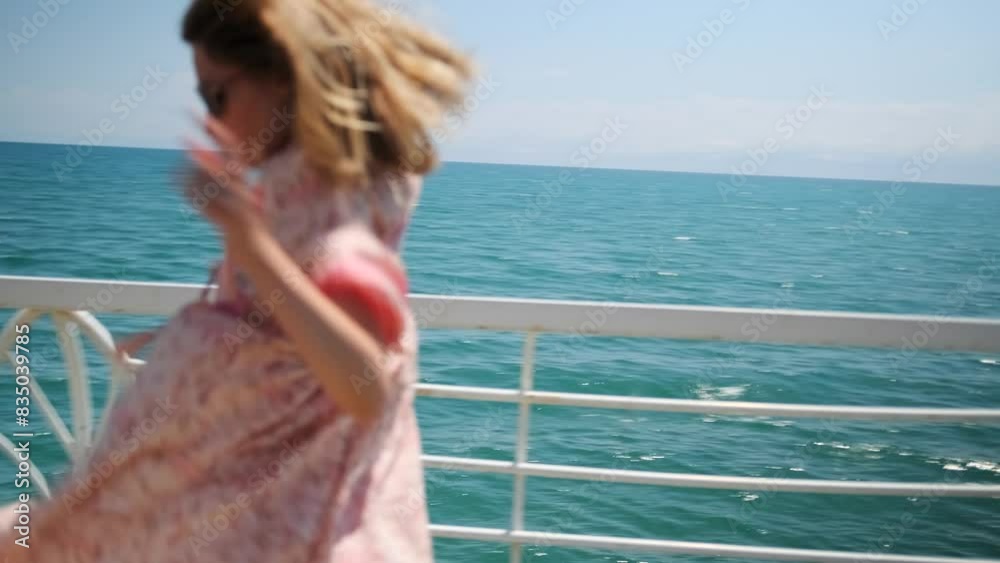 Young woman dancing on picturesque pier overlooking shiny blue ocean and cloudy sky on sunny day, summer vacation in tropical paradise. Young woman dancing on picturesque pier overlooking shiny blue ocean and cloudy sky on sunny day, summer vacation in tropical paradise.