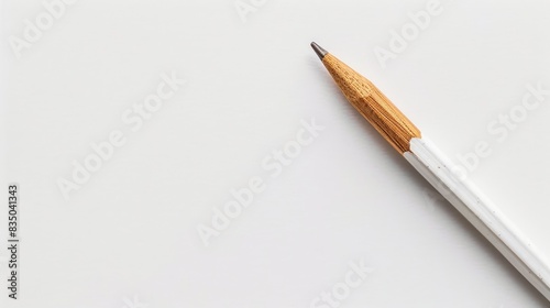 White natural wooden pencil on a white backdrop