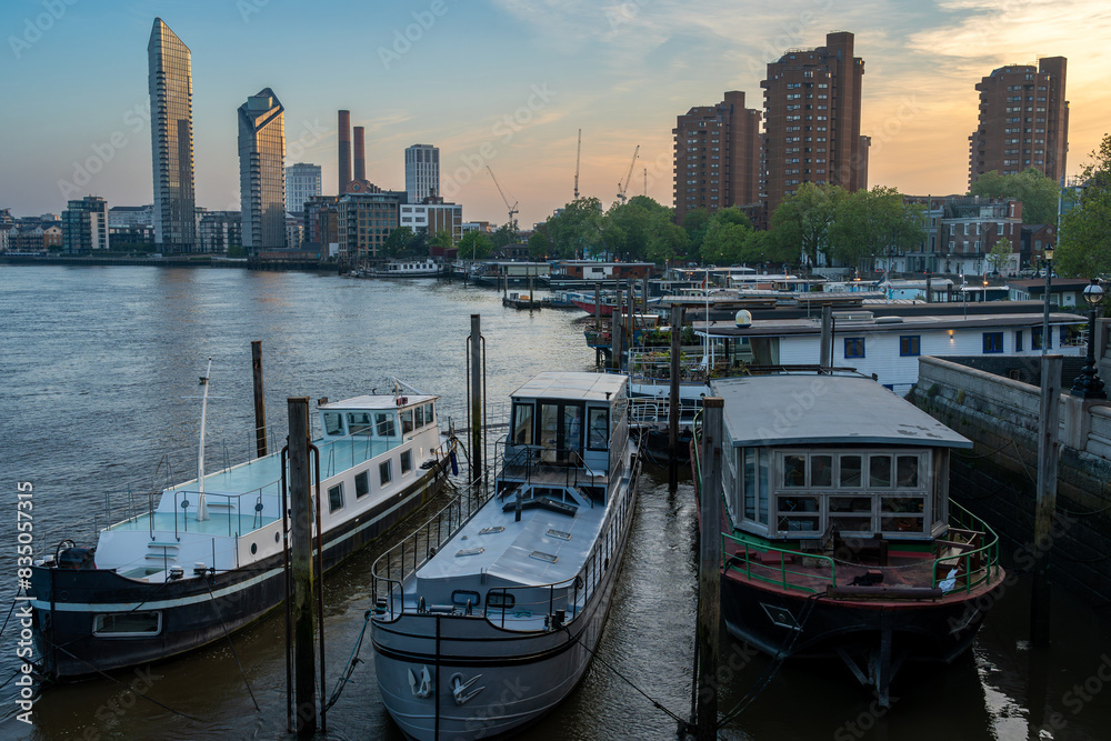 Skyline of London by sunset seen from the Battersea Bridge, view of river Thames and Chelsea Harbour Skyline of London by sunset seen from the Battersea Bridge, view of river Thames and Chelsea Harbour