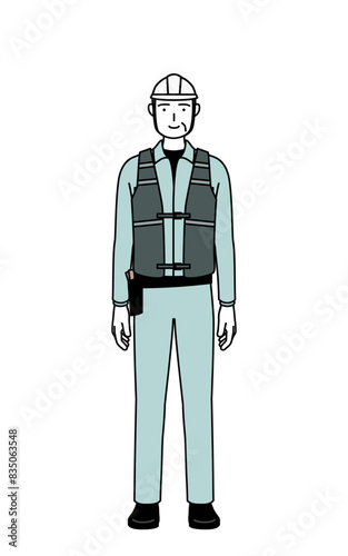 Senior male engineer in helmet and work wear with a smile facing forward