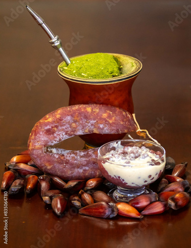 Typical Gaucho culture, yerba mate mate, red wine sago, pine nuts and rustic colonial salami photo