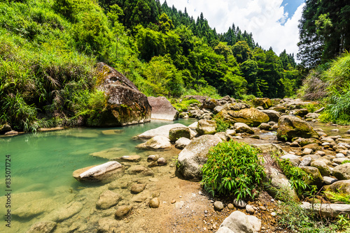 The river bank is covered with huge rocks and a crystal clear stream, Sun-Link-Sea Forest Recreation Area in Nantou, Taiwan. photo