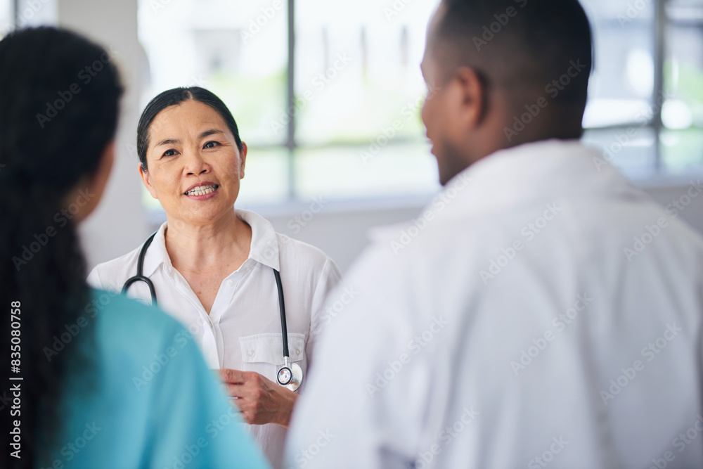 Multi-Ethnic Medical Team Discussing Patient Care in Hospital Setting Multi-Ethnic Medical Team Discussing Patient Care in Hospital Setting