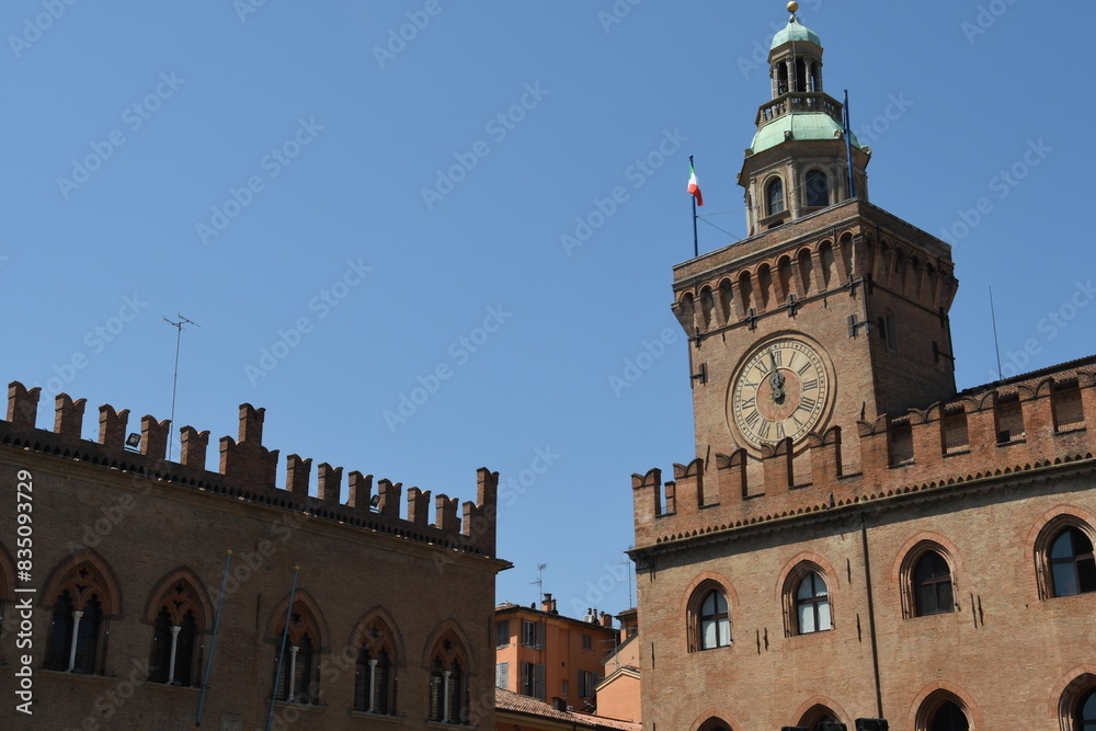 Obraz premium Piazza Maggiore is the heart of Bologna with the marbles of the basilica of San Petronio, Palazzo d'Accursio, Palazzo del Podestà, and the fountain of Neptune.