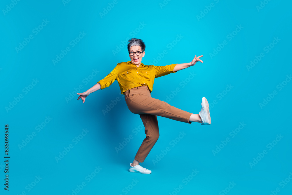 Full length photo of adorable good mood lady dressed shirt eyewear having fun empty space isolated blue color background