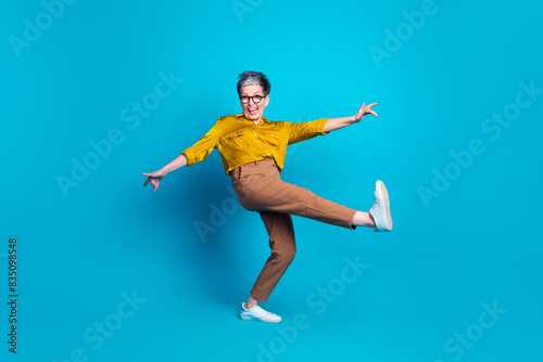 Full length photo of adorable good mood lady dressed shirt eyewear having fun empty space isolated blue color background