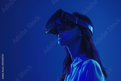 A woman wearing VR headset in blue light © zaen_studio