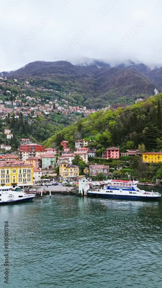 Ferry boats in Varenna on Como Lake in overcast day. Aerial vertical video Ferry boats in Varenna on Como Lake in overcast day. Aerial vertical video