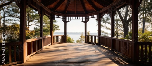 A path made of wood guides to the gazebo, offering a picturesque view with copy space image.