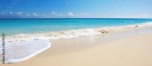 Scenic seaside view with a white sandy beach  turquoise blue sea  and clear sky on the horizon  perfect for a travel-themed copy space image.