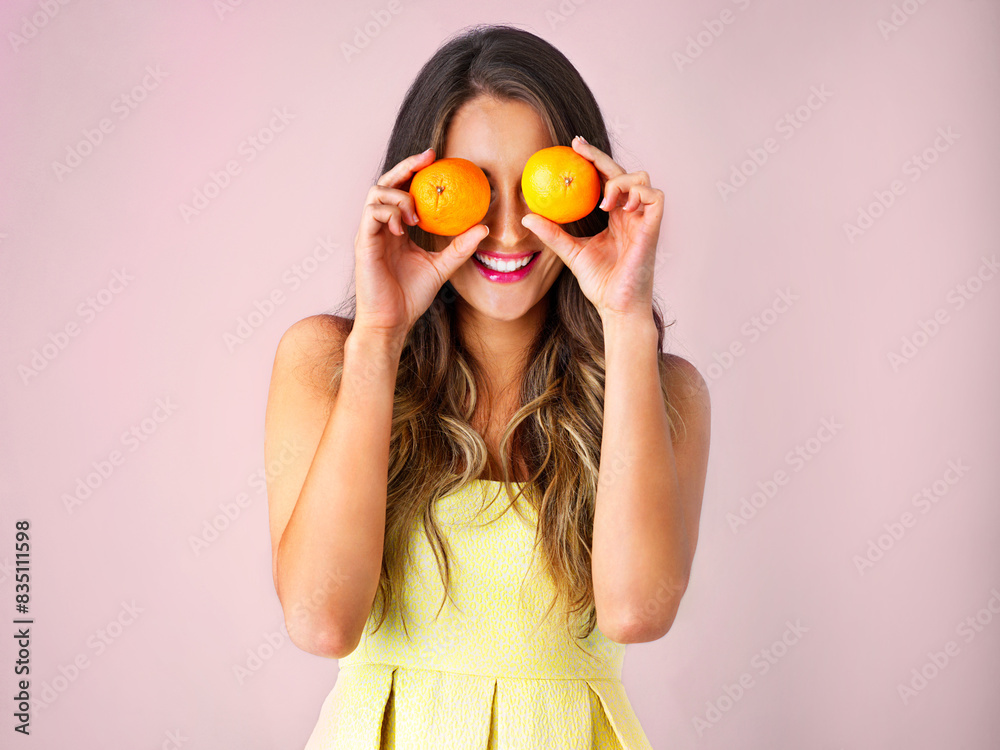 Happy, orange on eyes and woman on pink background for healthy eating, nutrition and detox for wellness. Food, smile and person with fruit for organic diet, wellbeing and natural vitamin c in studio Happy, orange on eyes and woman on pink background for healthy eating, nutrition and detox for wellness. Food, smile and person with fruit for organic diet, wellbeing and natural vitamin c in studio