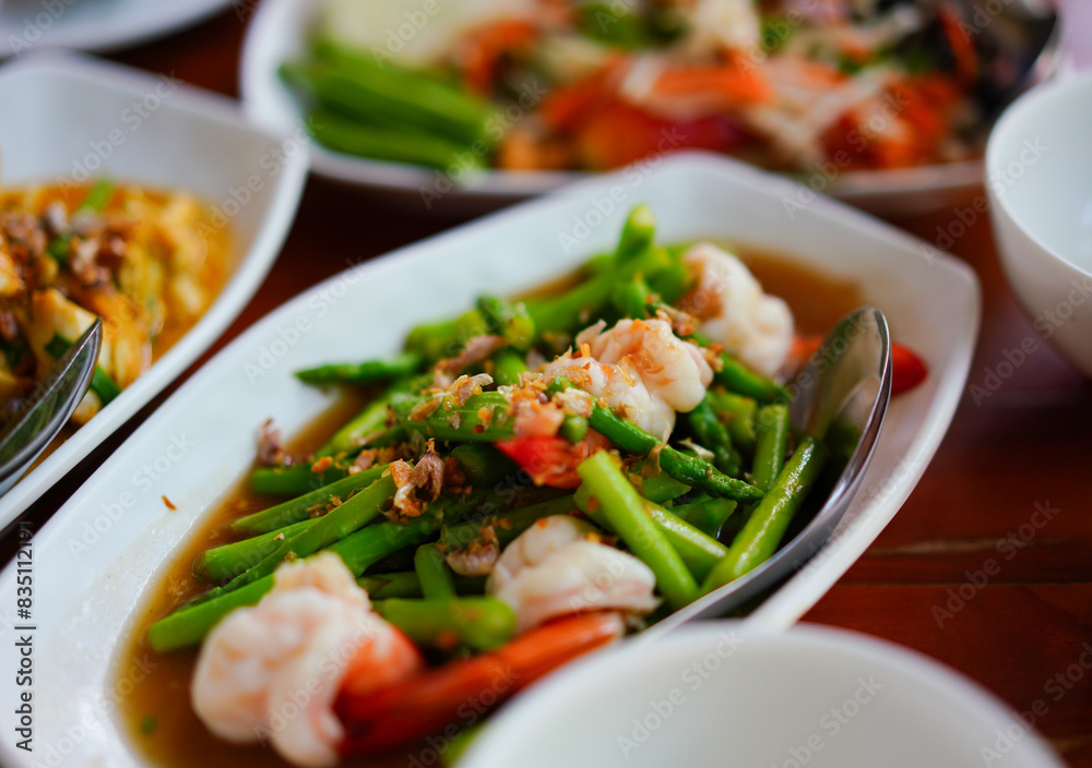 Asparagus stir fried with shrimp on Thai style table set Asparagus stir fried with shrimp on Thai style table set