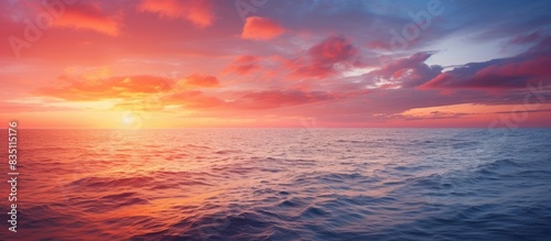 Vivid sunset over the tranquil sea  offering ample copy space image.