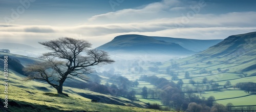 A serene morning view at Mam Tor during spring with a hint of snow, showcasing Edale and the scenic Hope Valley in the background, ideal for a copy space image.