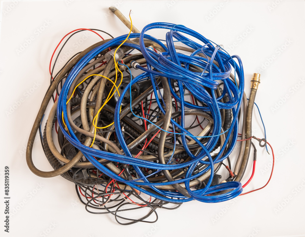 Bundle of used cables in different colors and sizes on a white background Bundle of used cables in different colors and sizes on a white background