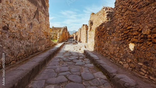 Via Stabiana, with its famous stepping stones and chariot ruts in Pompeii, Naples, Campania, Italy, an ancient Roman city buried by Mount Vesuvius in 79 AD photo