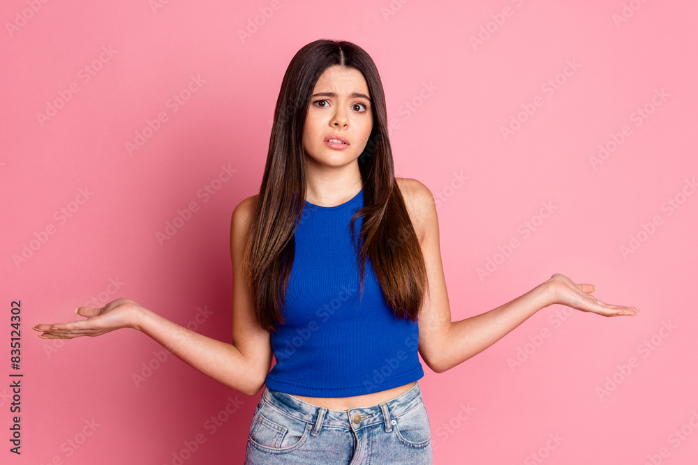 Photo of doubtful unsure girl wear tank top shrugging shoulders isolated pink color background Photo of doubtful unsure girl wear tank top shrugging shoulders isolated pink color background