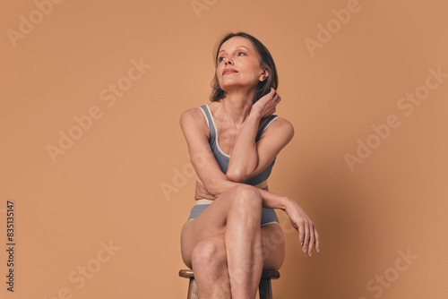 No filter photo of dreamy woman wear underwear look empty space isolated on beige color background