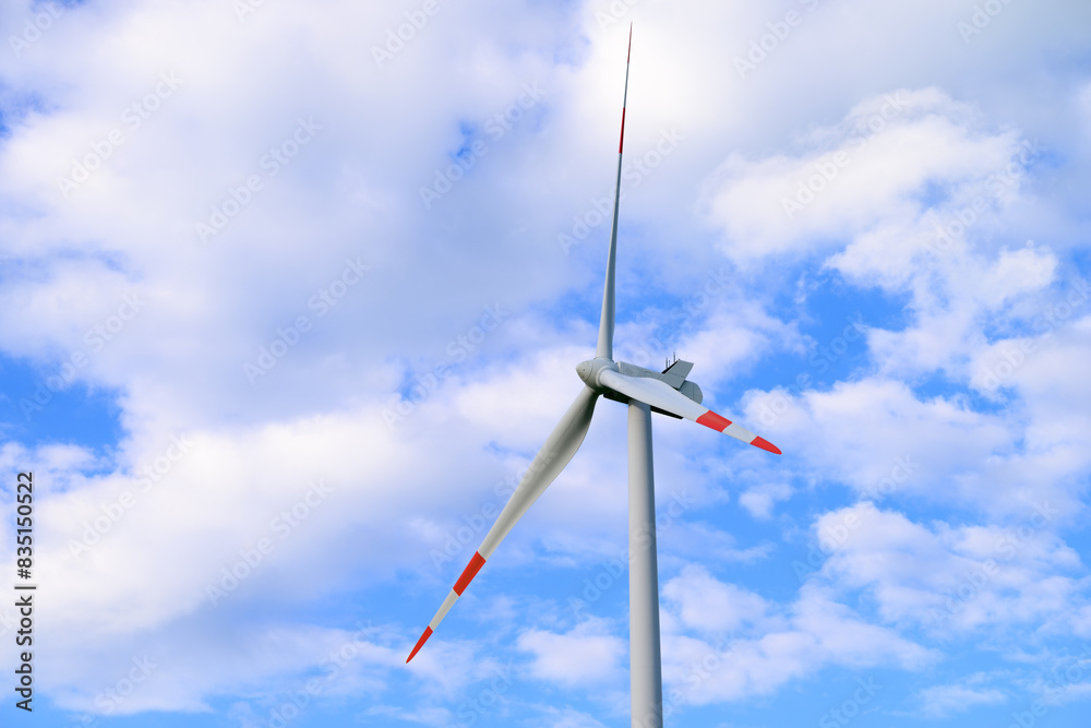 wind turbine against blue sky with some puffy clouds wind turbine against blue sky with some puffy clouds
