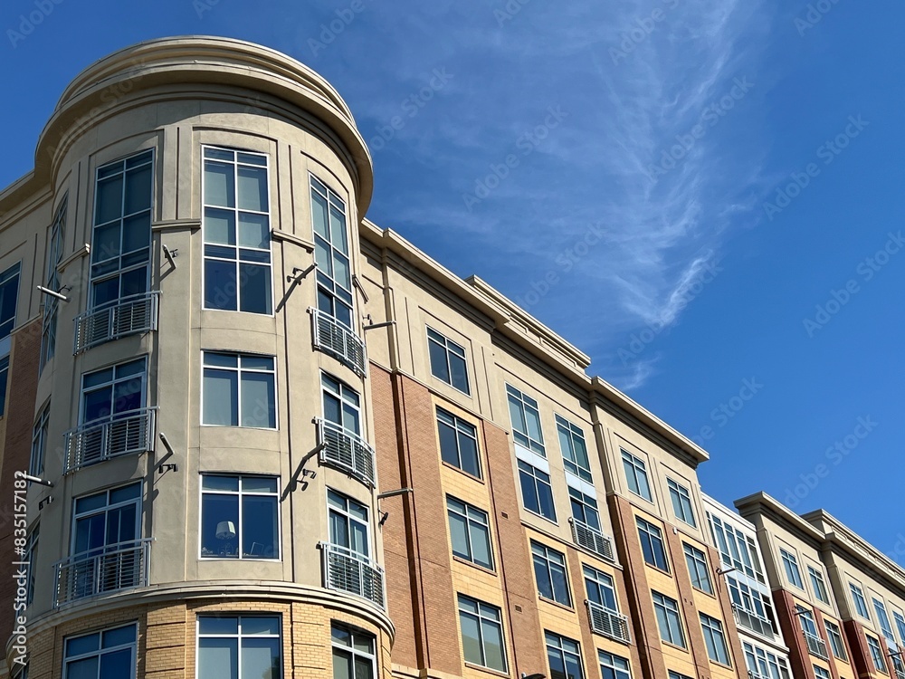 Modern apartment condo building against a blue sky with copy space Modern apartment condo building against a blue sky with copy space