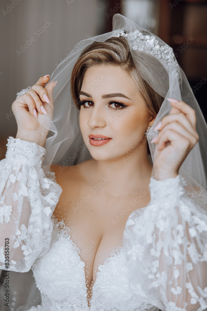 A woman in a white wedding dress is holding a veil over her face. Concept of elegance and sophistication, as the bride is getting ready for her wedding. The veil adds a touch of romance A woman in a white wedding dress is holding a veil over her face. Concept of elegance and sophistication, as the bride is getting ready for her wedding. The veil adds a touch of romance