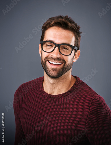 Studio, glasses and man with happiness, portrait and wellness with eye care, product and lens for vision. Black background, face and smile of person, prescription and eyewear with fashion in England © peopleimages.com