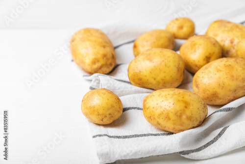 Young potatoes. Fresh potatoes  on a wooden background.Harvesting collection. organic  freshly dug potatoes. Agricultural background. Vegan. Vegetables.Place for text.Copy space