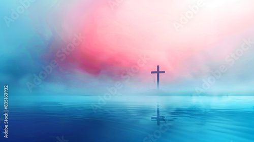 Silhouette of a solitary cross over a dreamy, misty, sea landscape.