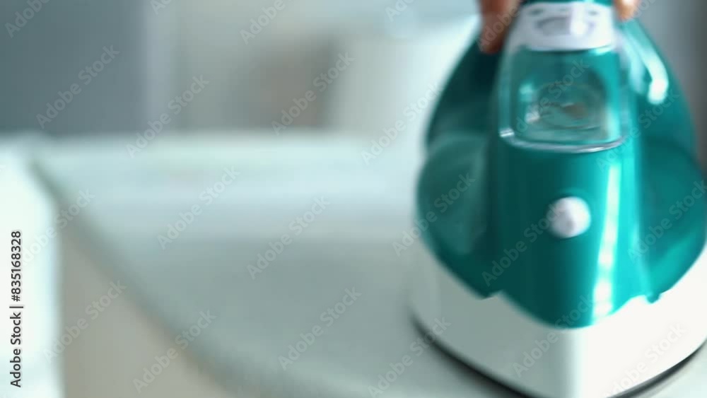 Close up, real-time video, zoom out, a Caucasian girl is wearing red sexy underwear and gently ironing clothes. Green iron is ironing white clean clothes on the ironing board, indoors, closeup. Close up, real-time video, zoom out, a Caucasian girl is wearing red sexy underwear and gently ironing clothes. Green iron is ironing white clean clothes on the ironing board, indoors, closeup.