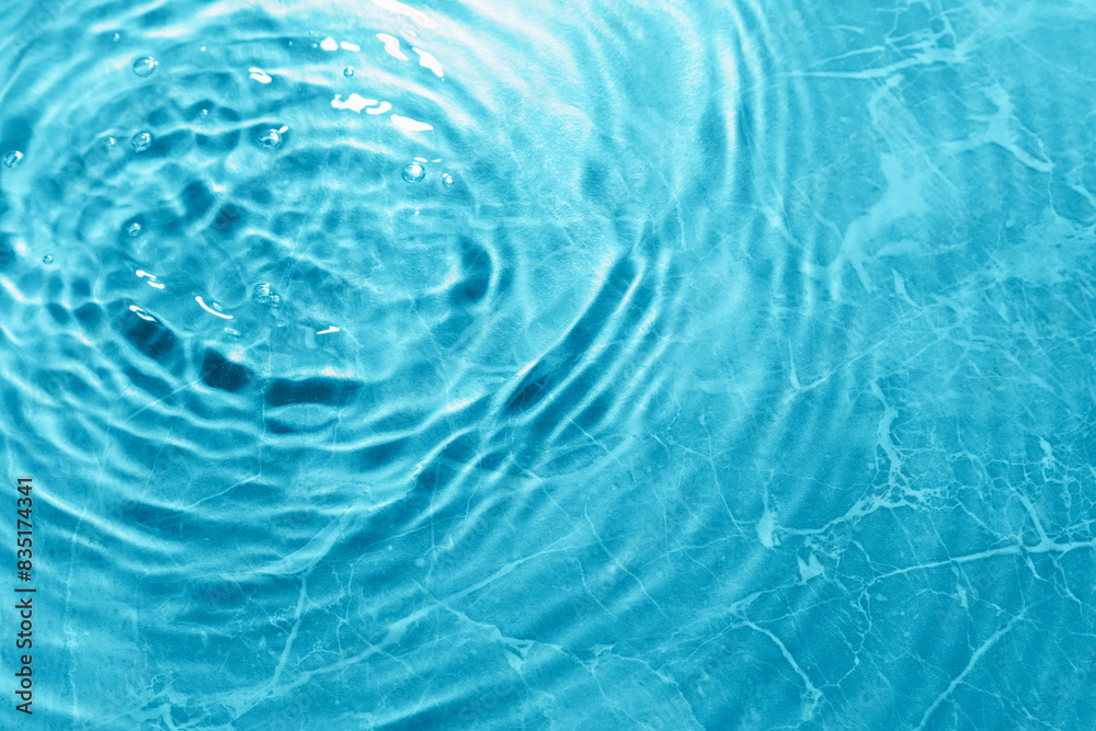Rippled surface of clear water on light blue background, top view Rippled surface of clear water on light blue background, top view
