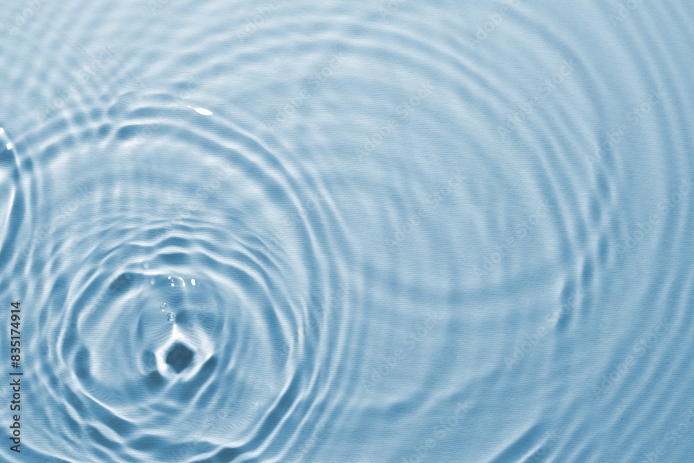 Rippled surface of clear water on light blue background, top view Rippled surface of clear water on light blue background, top view