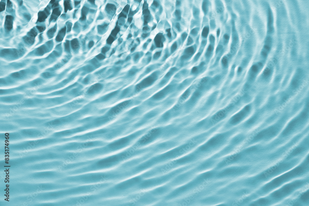 Rippled surface of clear water on light blue background, closeup Rippled surface of clear water on light blue background, closeup