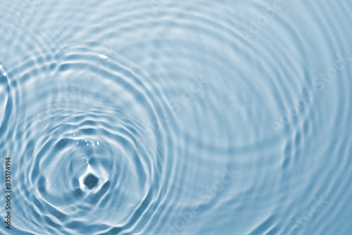 Rippled surface of clear water on light blue background  top view