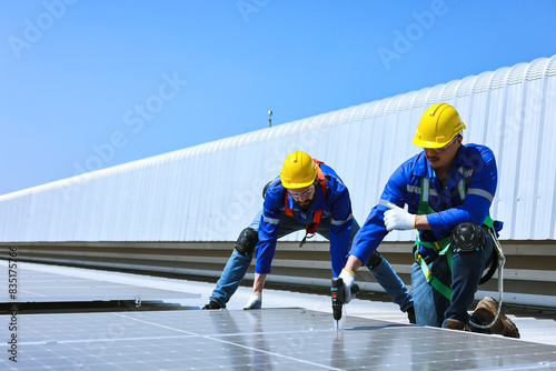 Wallpaper Mural Two caucasian engineers are installing solar panels on roof of factory. Torontodigital.ca