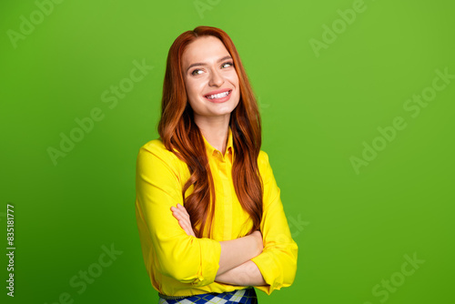 Photo of pretty lovely woman wear yellow clothes folded arms look empty space isolated on green color background © deagreez
