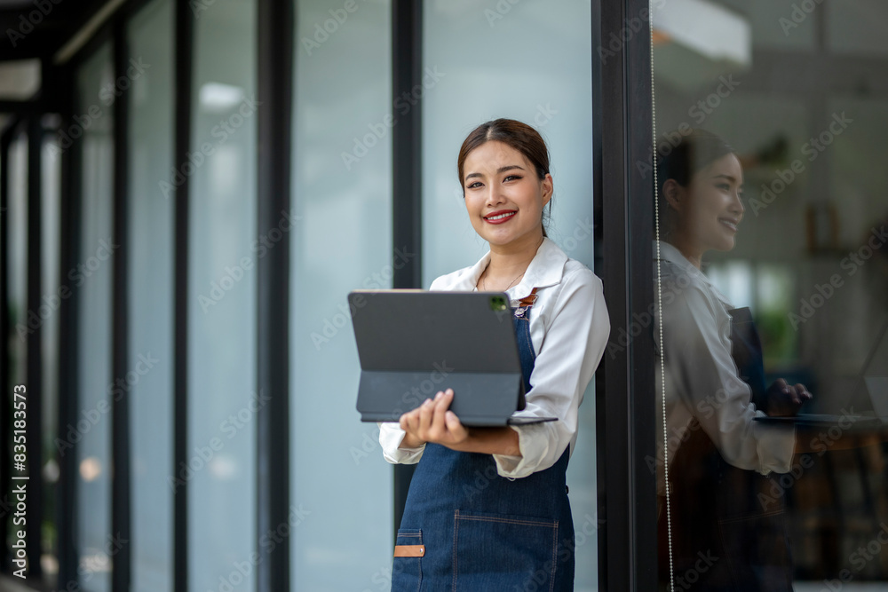 A woman is holding a laptop and smiling A woman is holding a laptop and smiling